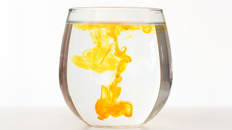 orange food dye in glass