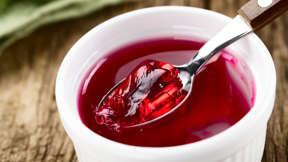 Red jello in bowl with spoon