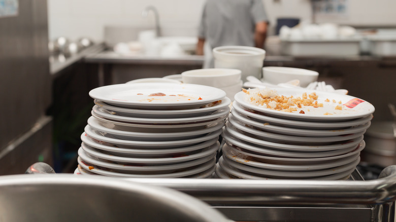 Dirty plates stacked in restaurant kitchen 