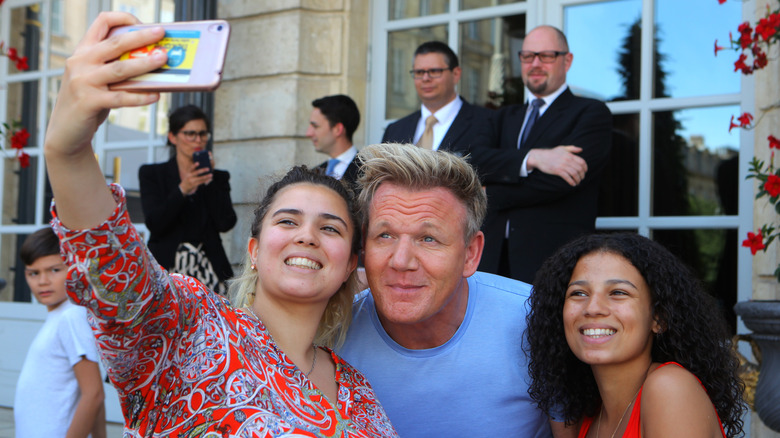 Gordon Ramsay posing with fans 