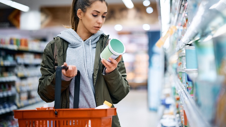 person browsing yogurt on grocery store