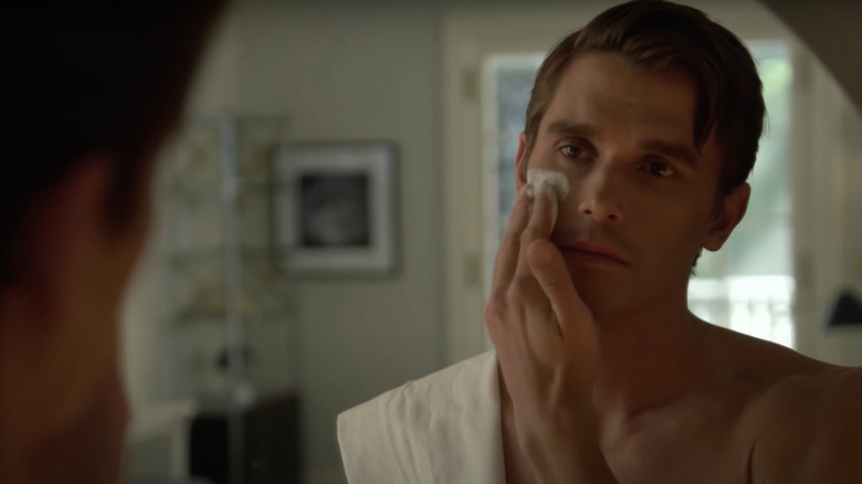 Antoni Porowski shaving in mirror