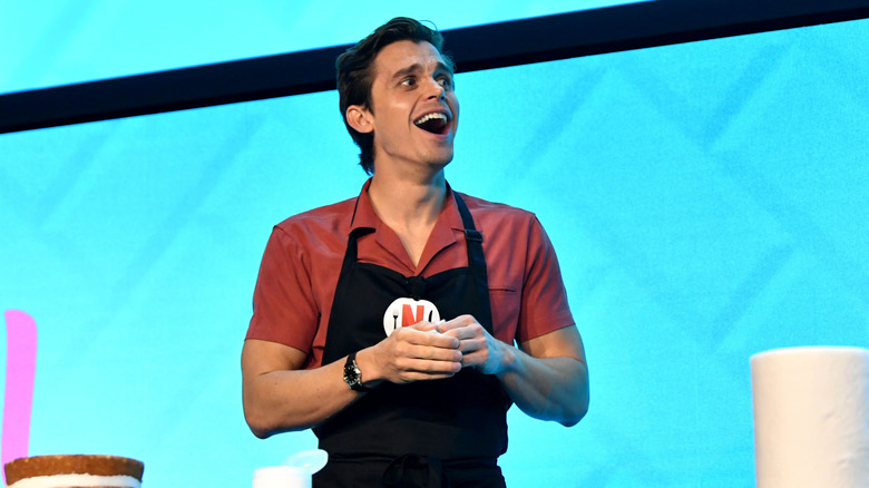 Antoni Porowski wearing an apron