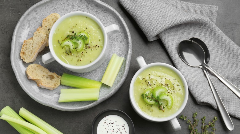 bowls of celery soup with bread