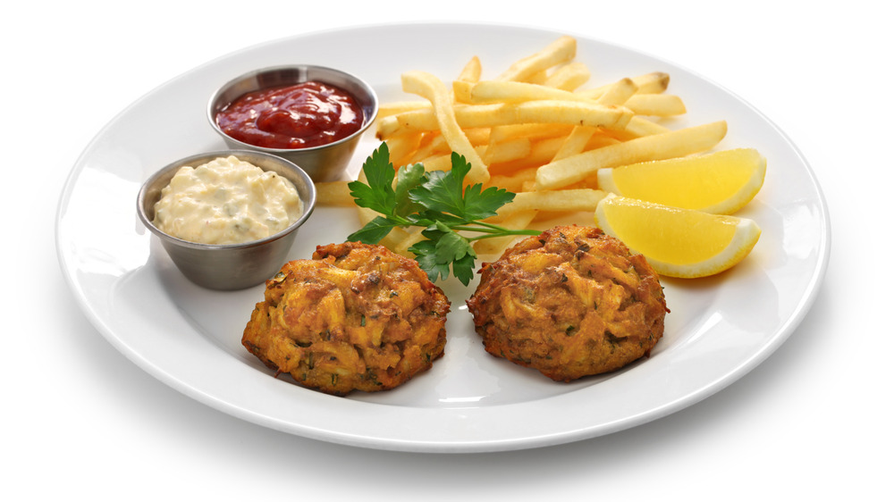 crab cakes on a plate with side dishes