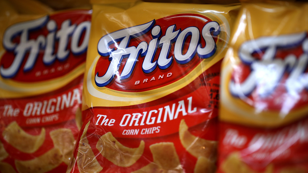 Bags of Fritos chips on a grocery store shelf