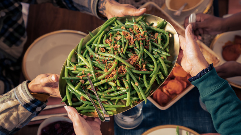 People passing green beans