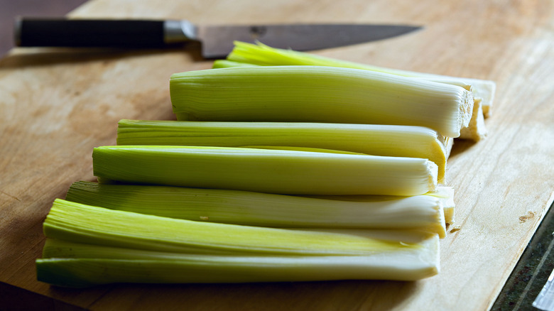 leeks on cutting board with knife