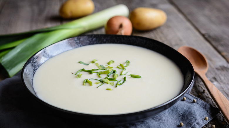 french leek and potato soup in a black bowl