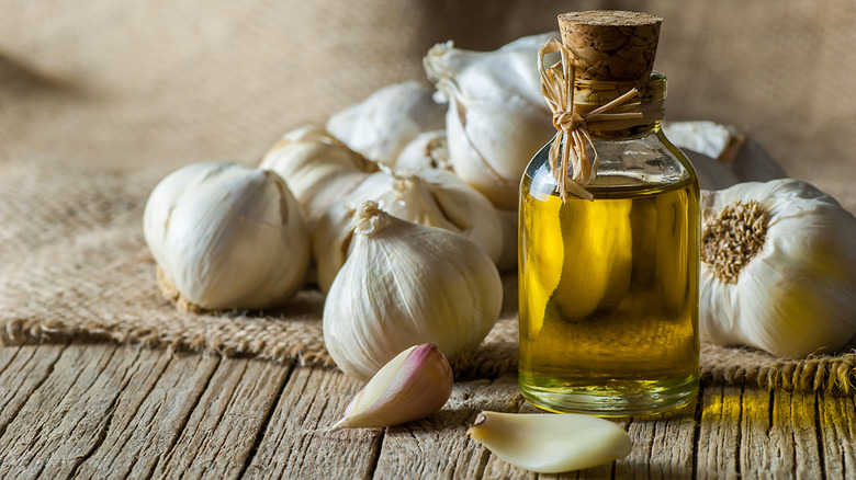 garlic and olive oil on wooden table