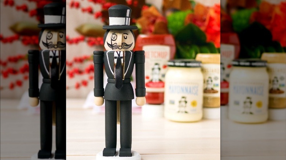 Small statue of a man in suit and monocle