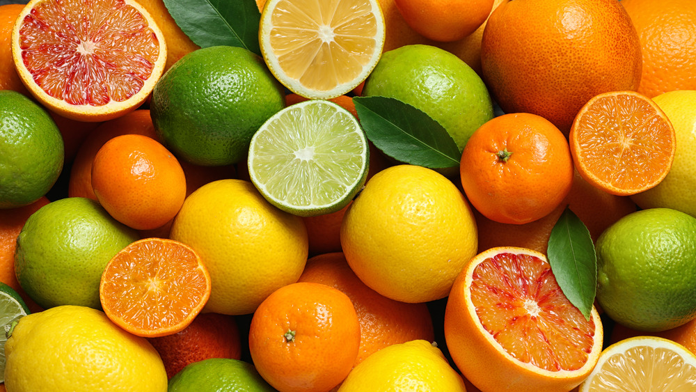 A pile of different types of citrus fruits