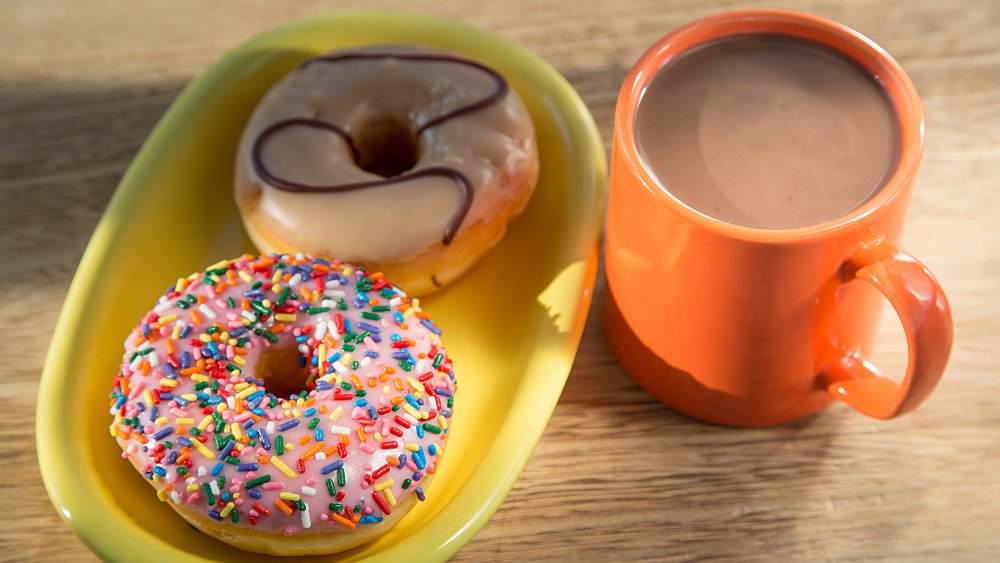 Two donuts with a cup of coffee
