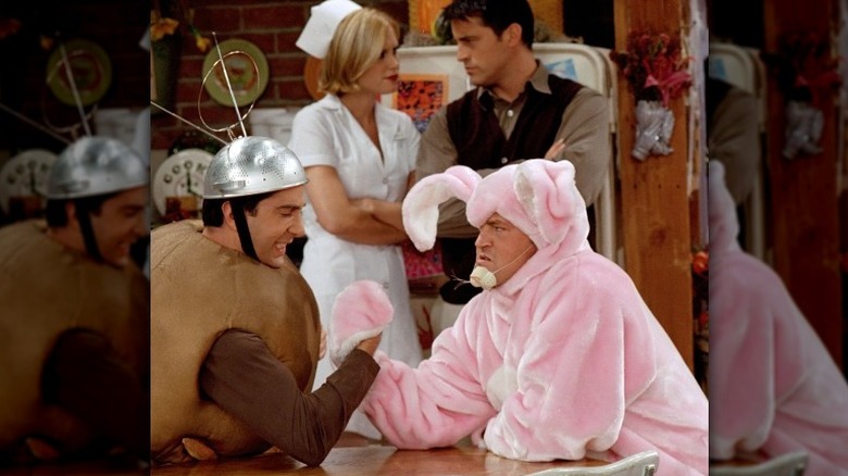 Ross and Chandler arm-wrestling in costumes