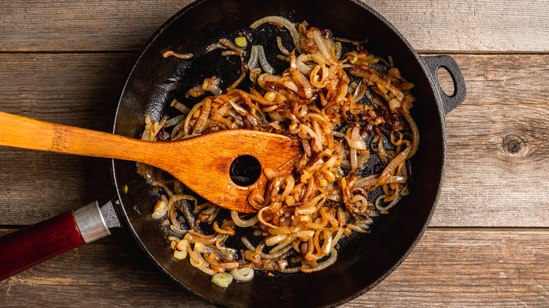 sautéed white onions wooden spatula