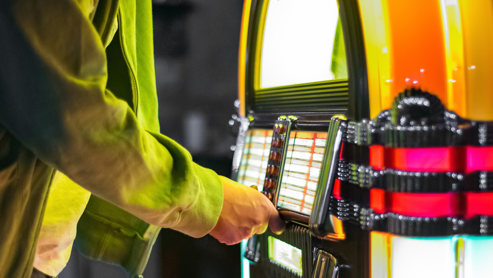 Man selecting a song on a jukebox