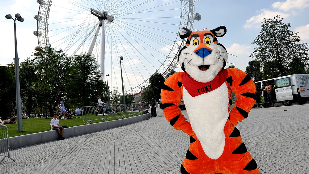Person in Tony the Tiger costume standing in front of ferris wheel