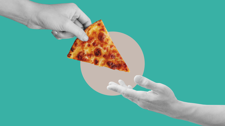 hand giving another hand pizza