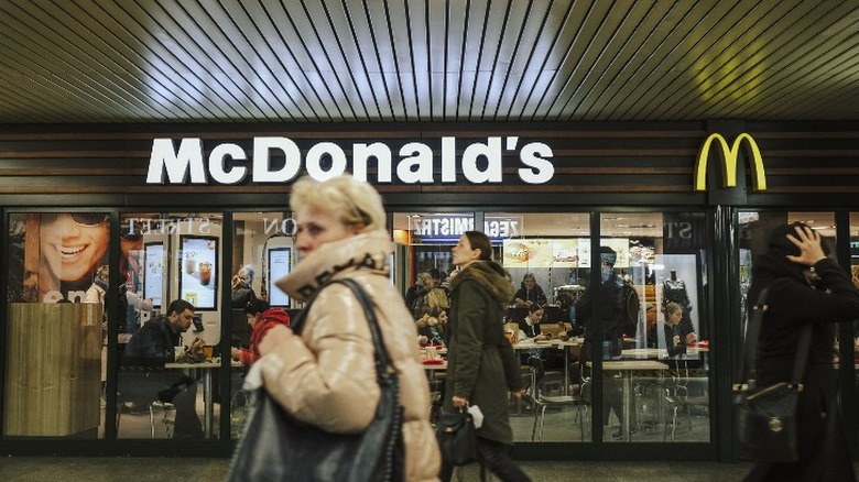 Person walking past McDonald's restaurant