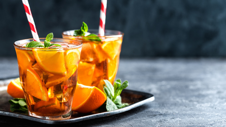 cocktails on a plate with an orange and mint