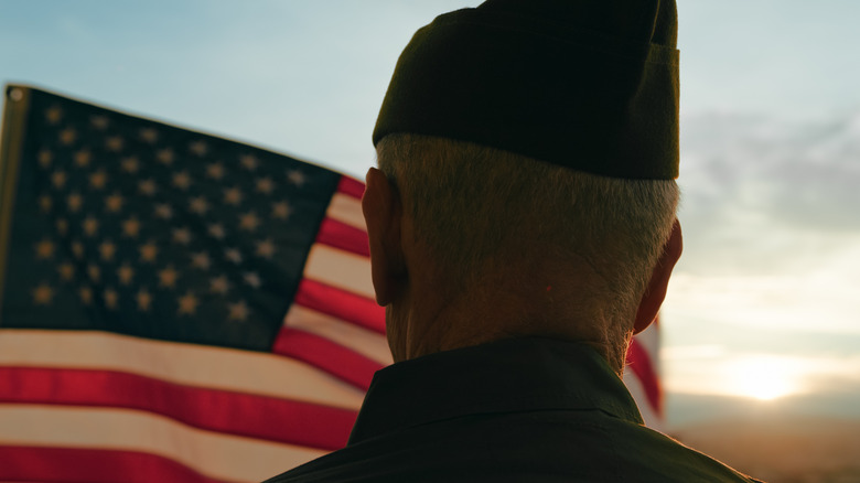 Person standing by the American flag for Veterans Day