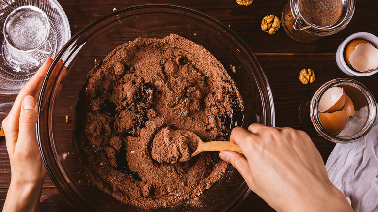 Hands mixing chocolate batter