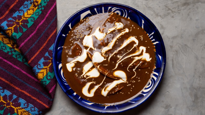 Mole enchiladas on a blue dish 