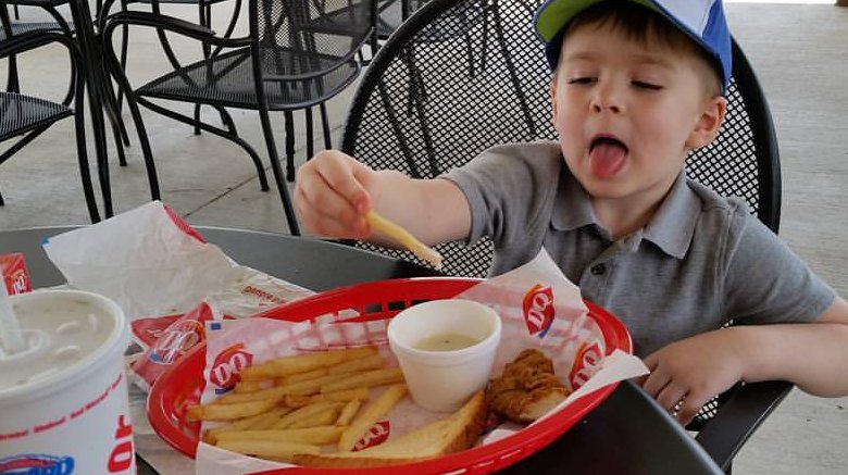 Boy eating Dairy queen fries