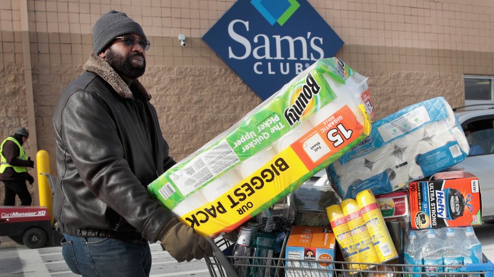 man with full grocery cart at Sam's Club