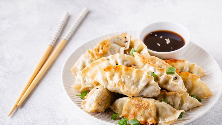 Chopsticks next to gyoza