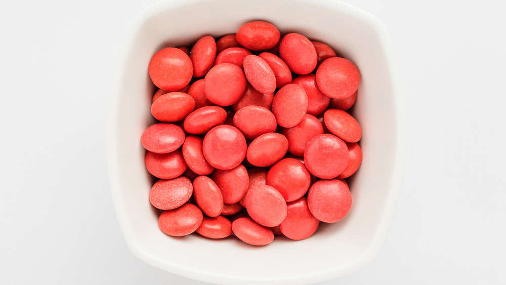 A bowl full of red candies that