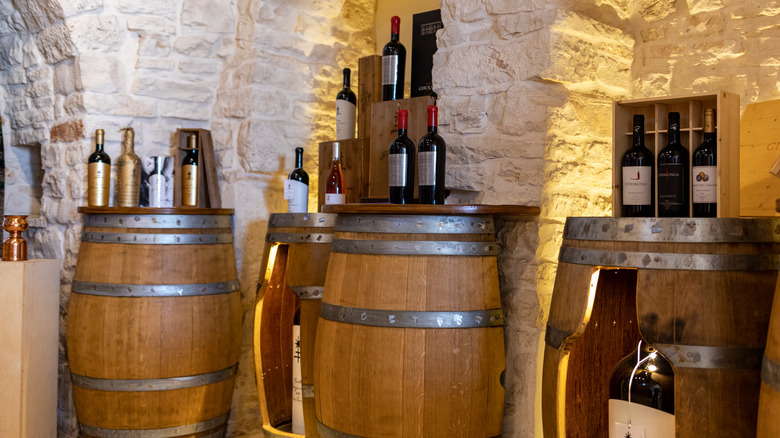 Wine bottles on barrels in a cellar