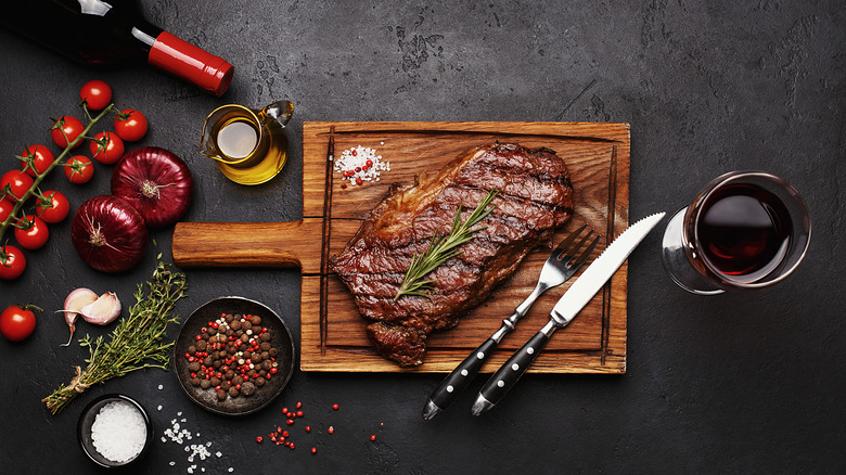 Steak with glass of wine and seasonings