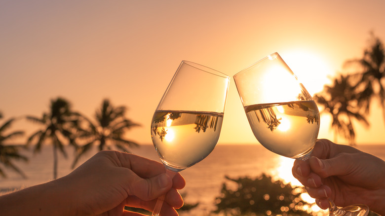 Glasses of white wine in the sunset