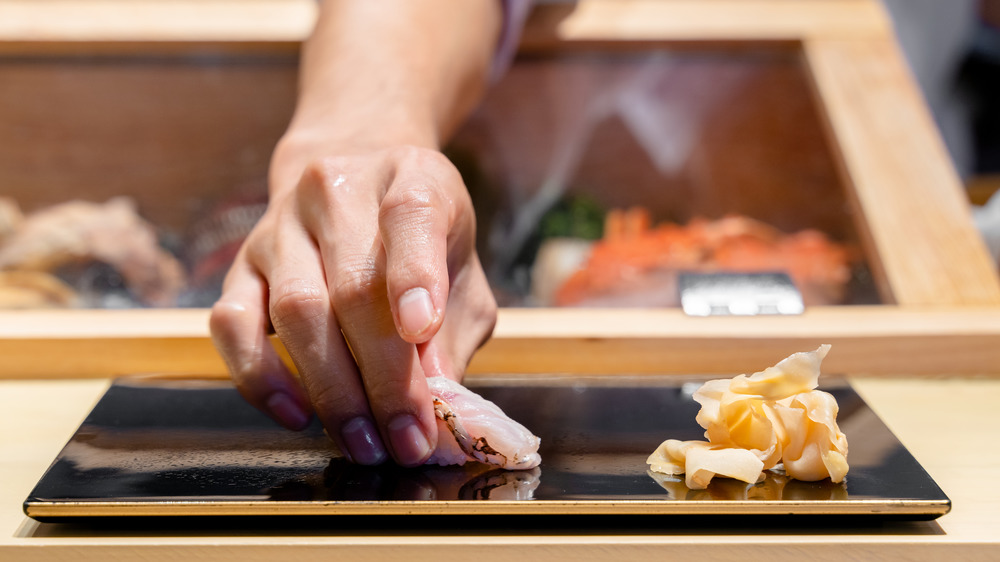 Chef serving nigiri