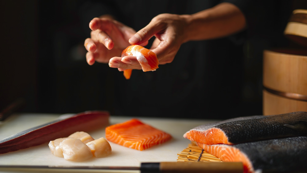 Chef preparing salmon sushi