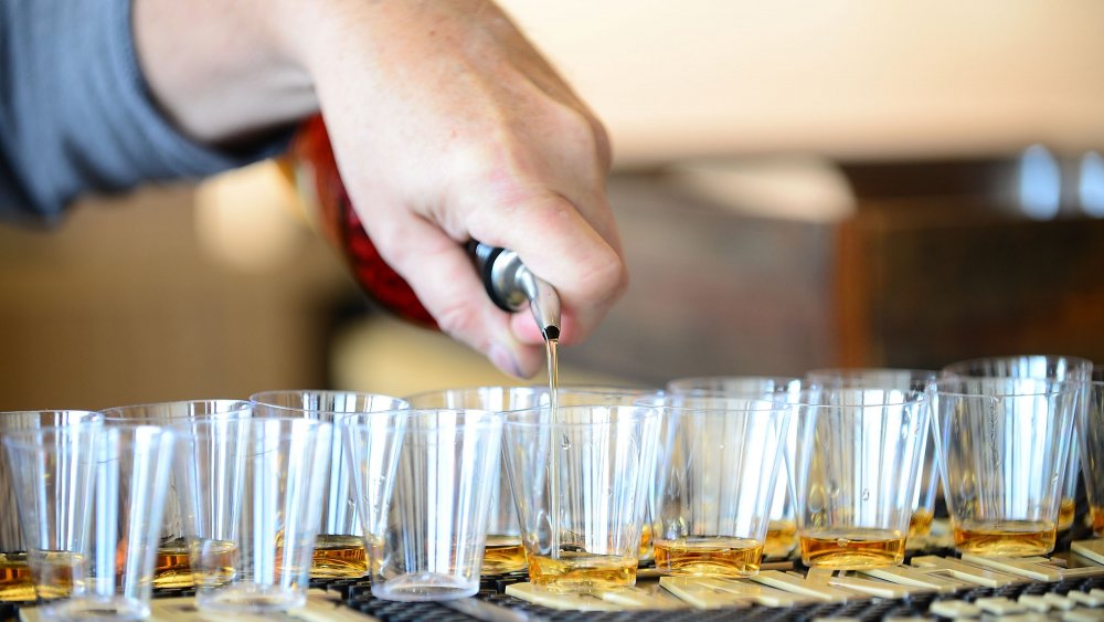 Pouring rum in shot glasses