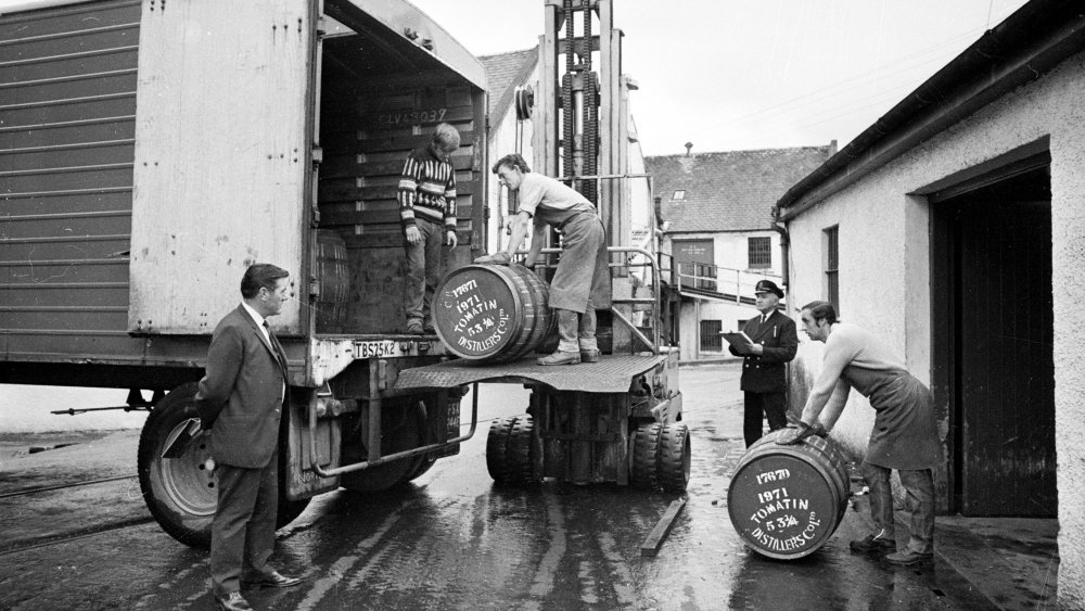 Men loading barrels of scotch into a truck