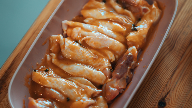 Cut chicken thighs in marinade