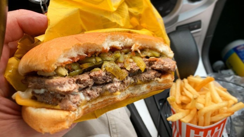 Hand holding the Whataburger hatch green chile burger