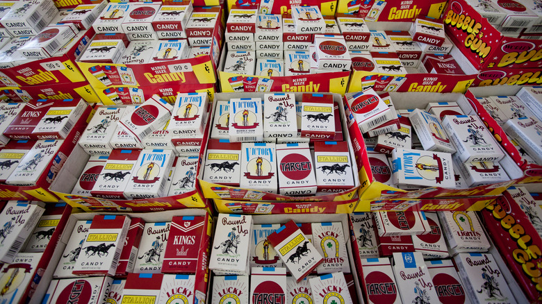 Many boxes of candy cigarettes in pile