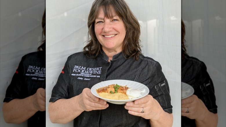 Gale Gand poses with a plate of food