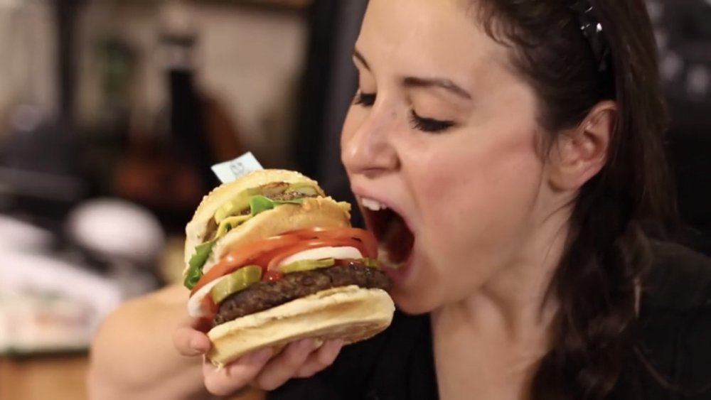 Woman eating homemade McWhopper