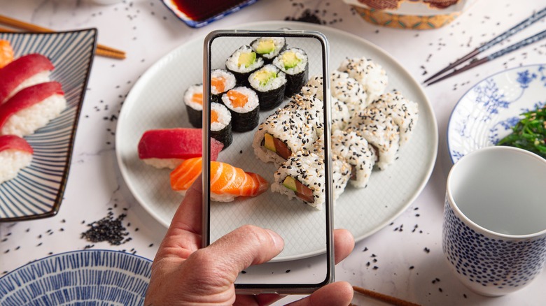 taking photo of sushi