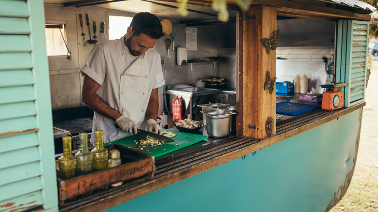 Food truck chef surrounded by ingredients 