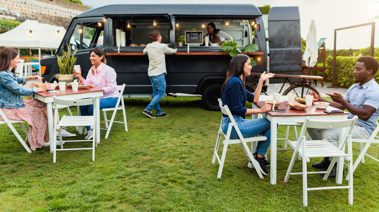 People enjoying a food truck service