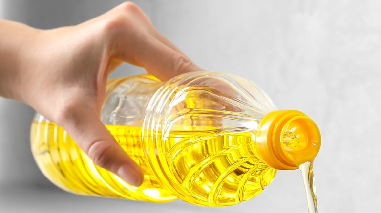 Hand pouring vegetable oil