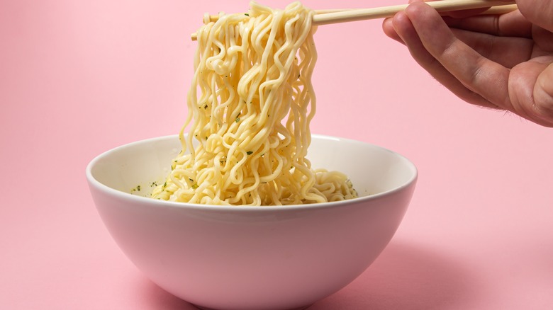 Chopsticks and a bowl of noodles