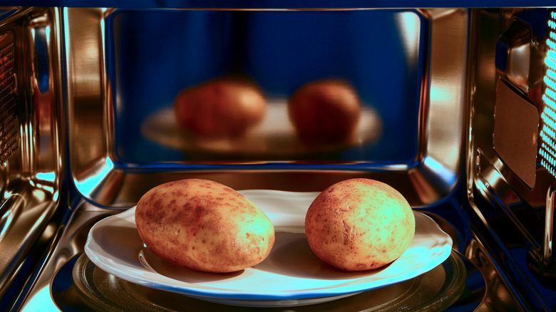 Potatoes on plate in microwave