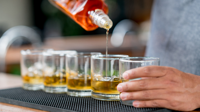 Pouring rum into glasses